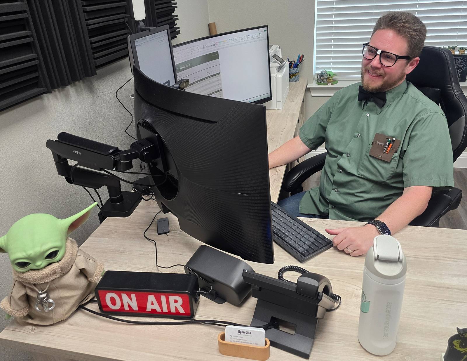 Ryan Otto at his desk with the ON AIR sign lit